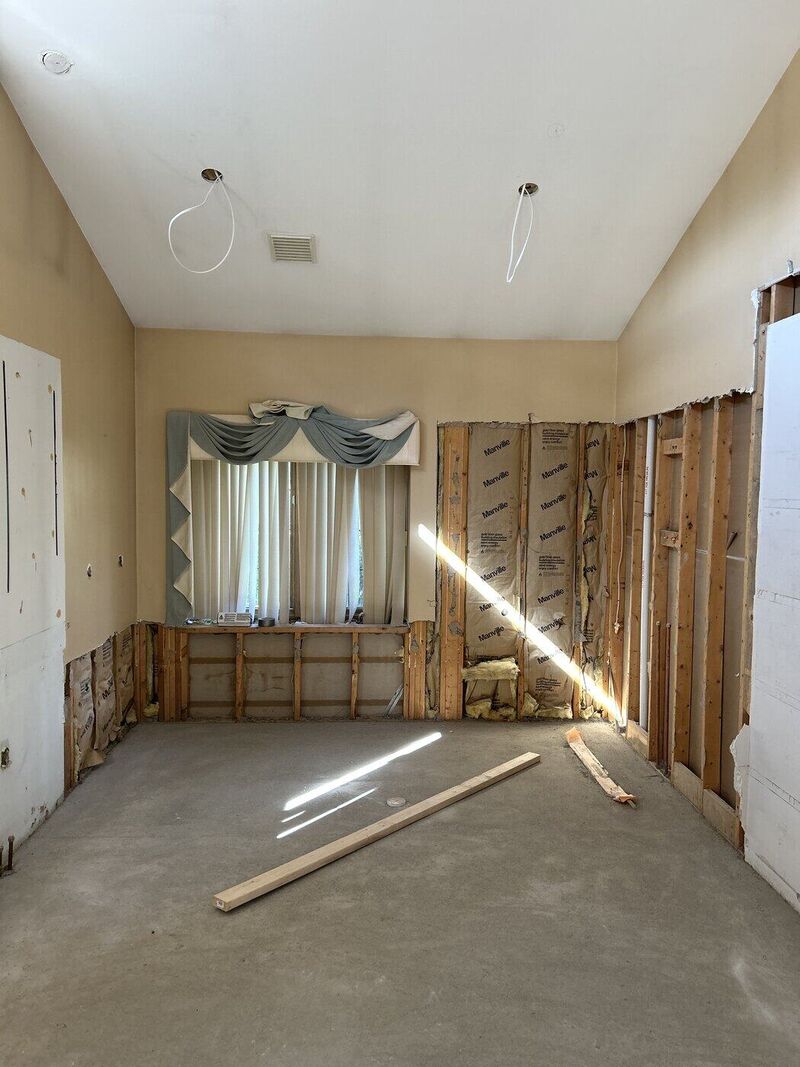 From the middle of the room, facing the shower. Primary bath, High-End Slab Bath